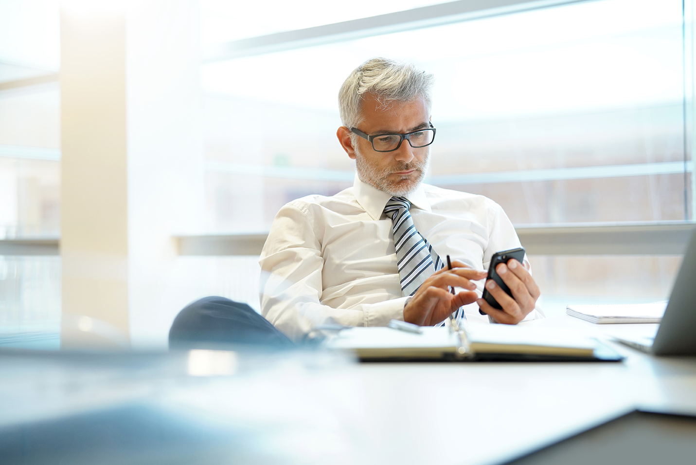 a photo of an attorney looking at a phone to send to Phone Extraction Data, LLC